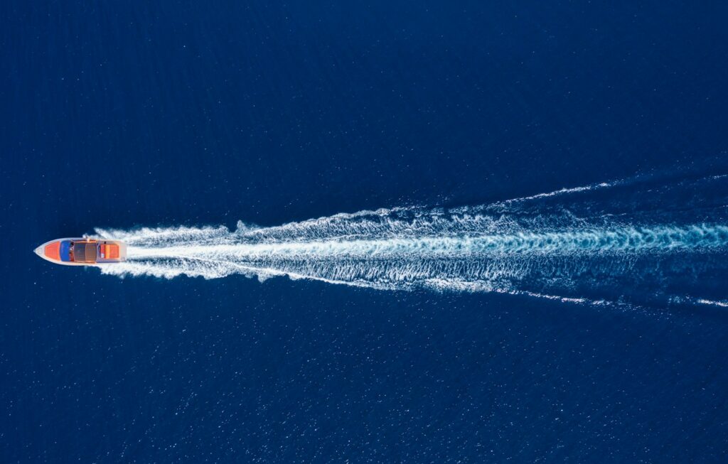 Fast boat at the sea in Bali, Indonesia. Aerial view of luxury floating boat