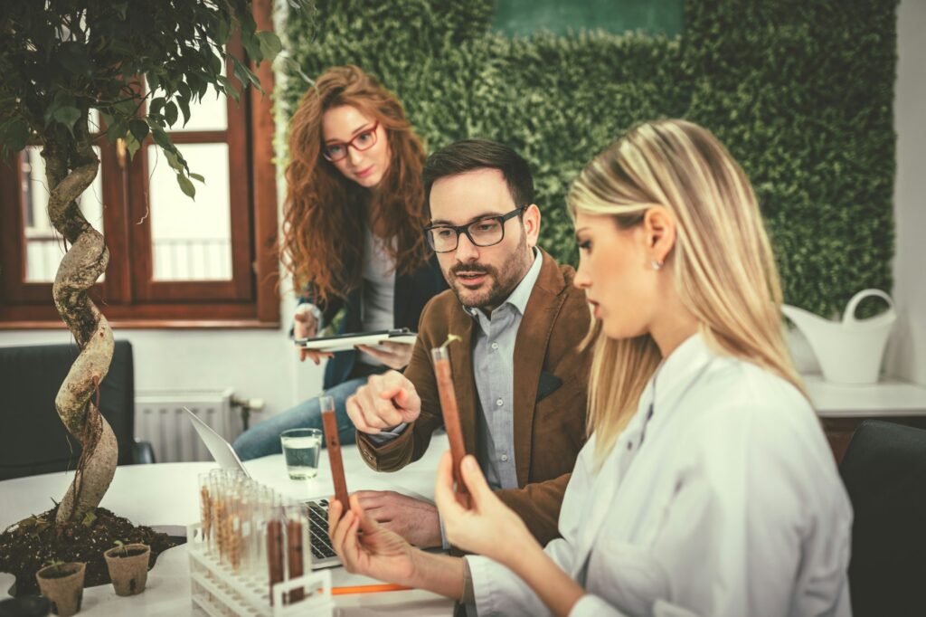 Scientist Examining Samples With Plants